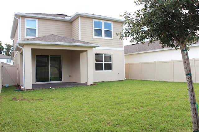 back of property featuring a yard and a patio area