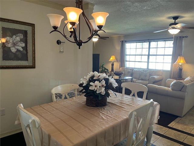 tiled dining area featuring ceiling fan, a textured ceiling, and ornamental molding