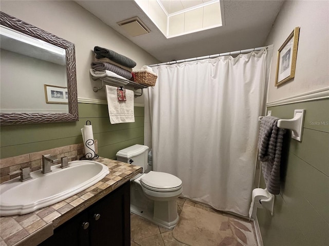 bathroom with walk in shower, tile patterned flooring, vanity, and toilet