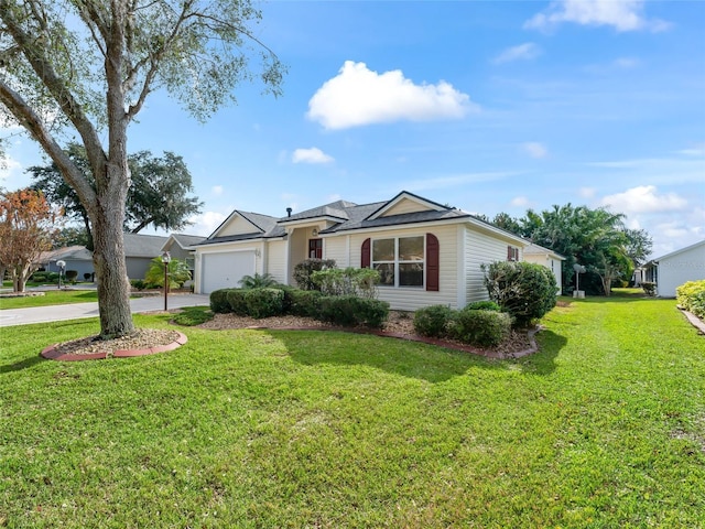 ranch-style house with a garage and a front lawn