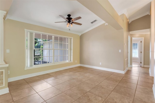 tiled empty room featuring decorative columns, ceiling fan, and crown molding