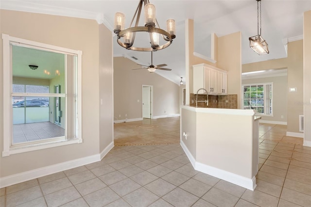 kitchen with pendant lighting, lofted ceiling, backsplash, ceiling fan with notable chandelier, and light tile patterned floors