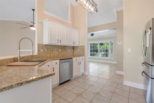 kitchen with lofted ceiling, white cabinets, sink, ceiling fan, and appliances with stainless steel finishes