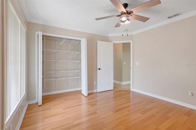 unfurnished bedroom featuring crown molding, ceiling fan, a closet, and light hardwood / wood-style floors