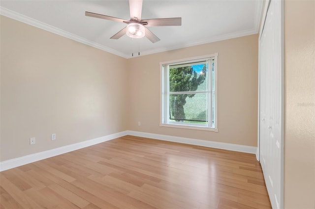 spare room with ceiling fan, light hardwood / wood-style floors, and crown molding