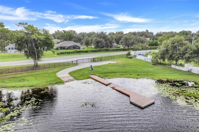 surrounding community with a yard and a water view