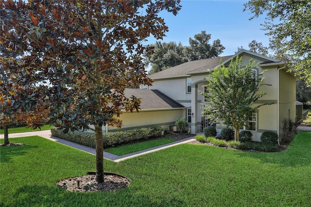 view of property hidden behind natural elements with a front lawn