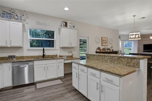 kitchen featuring white cabinets, dishwasher, sink, and a wealth of natural light