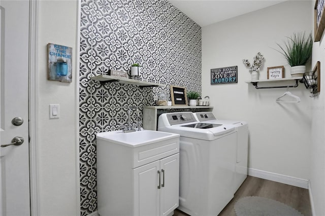 clothes washing area featuring separate washer and dryer and wood-type flooring