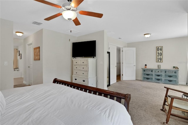 carpeted bedroom with ceiling fan and ensuite bath