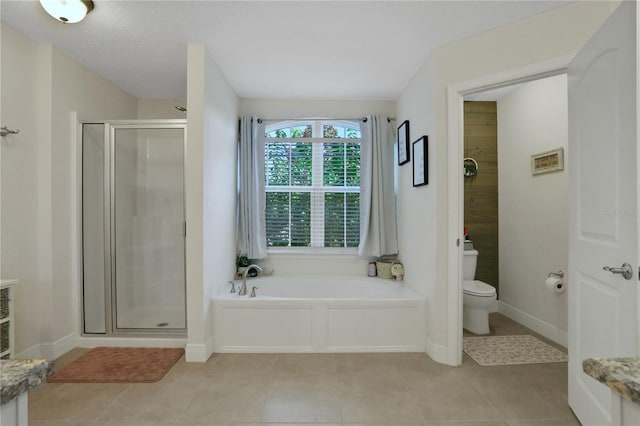 bathroom with tile patterned flooring, separate shower and tub, and toilet