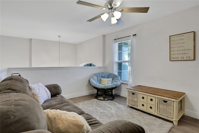 living room featuring ceiling fan and light hardwood / wood-style flooring