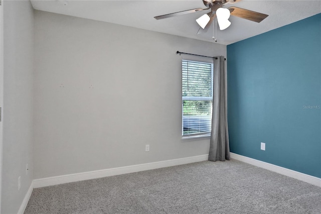 spare room with ceiling fan and carpet