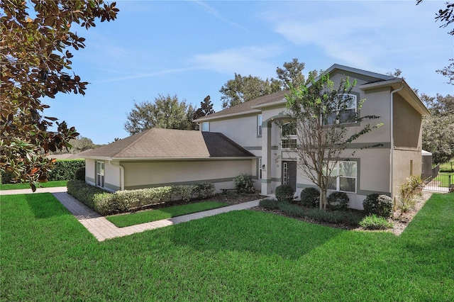 view of front of property featuring a front yard and stucco siding