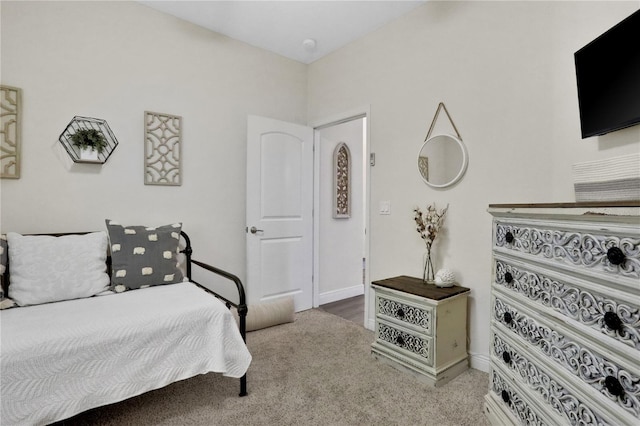 carpeted bedroom featuring baseboards