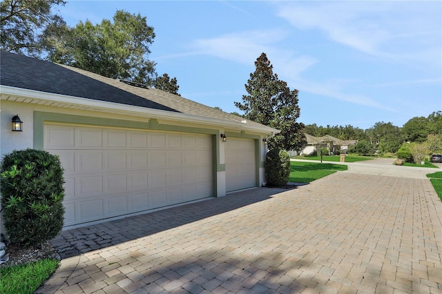 garage with decorative driveway