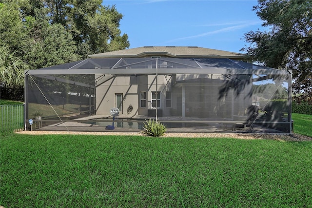 rear view of house featuring a lanai, a patio area, a lawn, and stucco siding