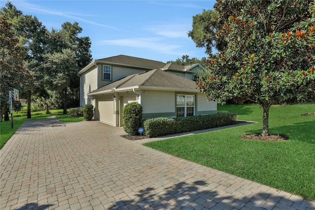 view of side of property with an attached garage, a shingled roof, a yard, decorative driveway, and stucco siding