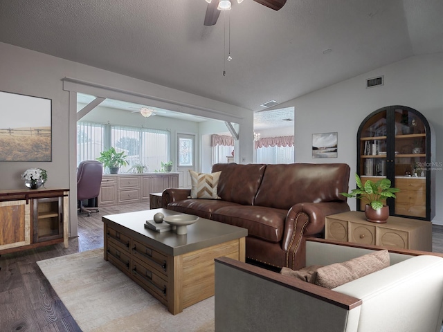 living room featuring ceiling fan, a textured ceiling, lofted ceiling, and dark hardwood / wood-style flooring