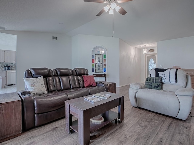 living room featuring lofted ceiling, light hardwood / wood-style floors, and ceiling fan