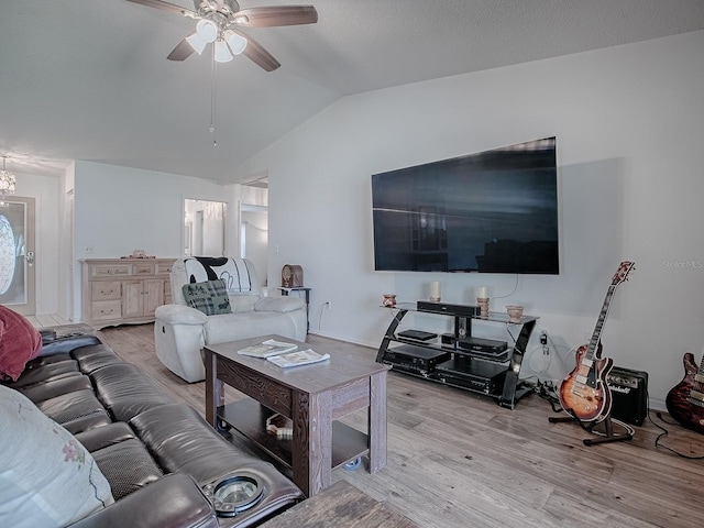 living room featuring lofted ceiling, light hardwood / wood-style floors, and ceiling fan