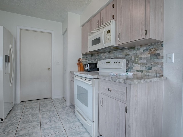 kitchen with backsplash, white appliances, light brown cabinets, light tile patterned floors, and a textured ceiling