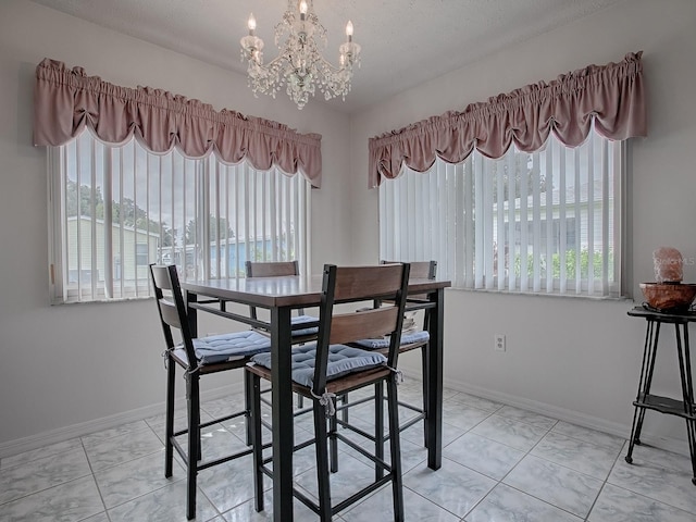 dining space with a notable chandelier and a textured ceiling