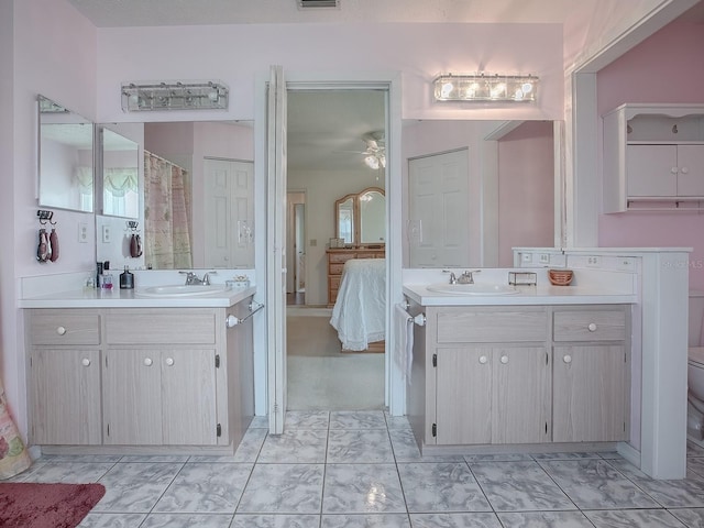 bathroom with ceiling fan, vanity, and toilet