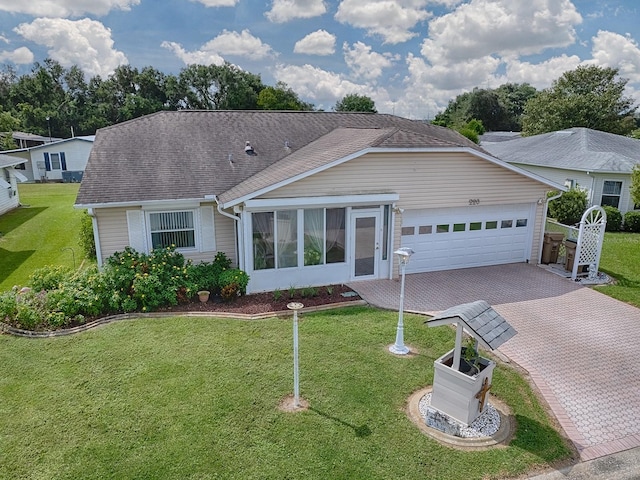 ranch-style home with a garage and a front lawn