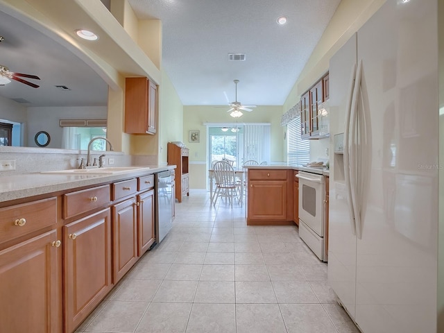 kitchen featuring ceiling fan, lofted ceiling, plenty of natural light, and white appliances