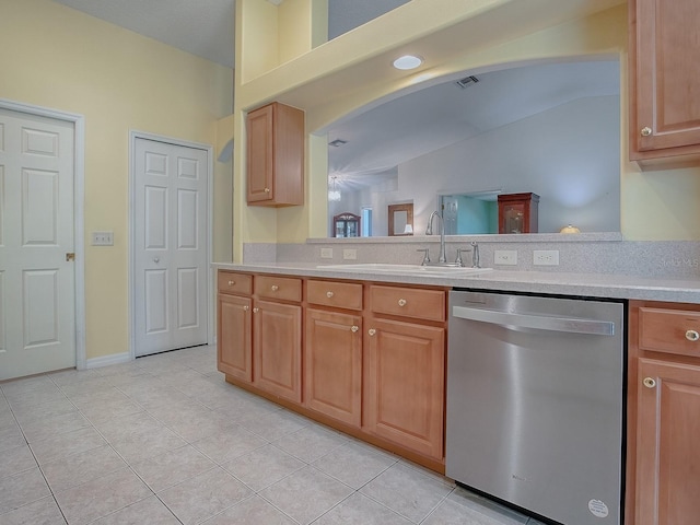 kitchen with stainless steel dishwasher, vaulted ceiling, sink, and light tile patterned floors