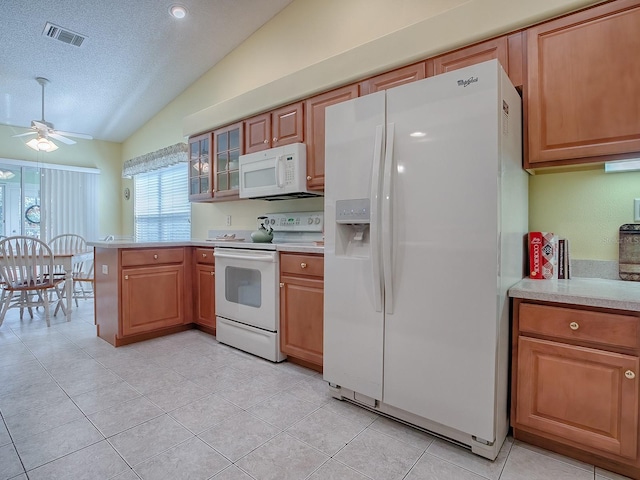 kitchen featuring vaulted ceiling, white appliances, light tile patterned floors, a textured ceiling, and ceiling fan