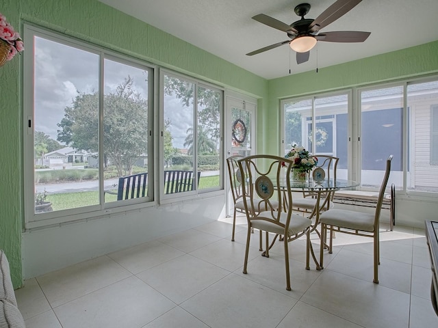 sunroom with ceiling fan and a healthy amount of sunlight