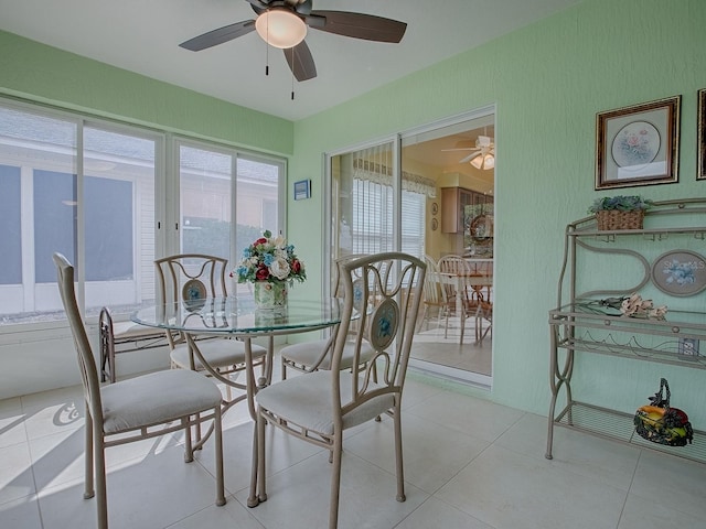 tiled dining space featuring ceiling fan