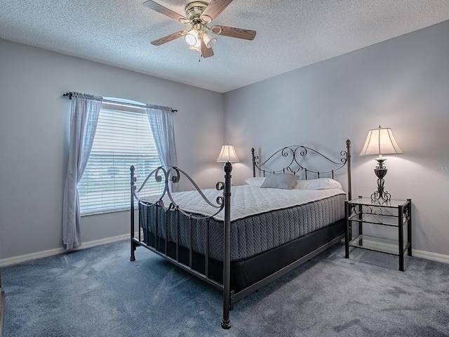 carpeted bedroom featuring ceiling fan and a textured ceiling