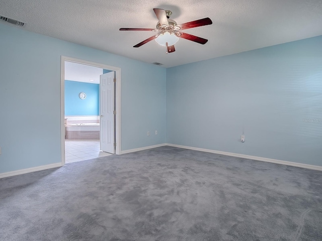 empty room with a textured ceiling, light carpet, and ceiling fan