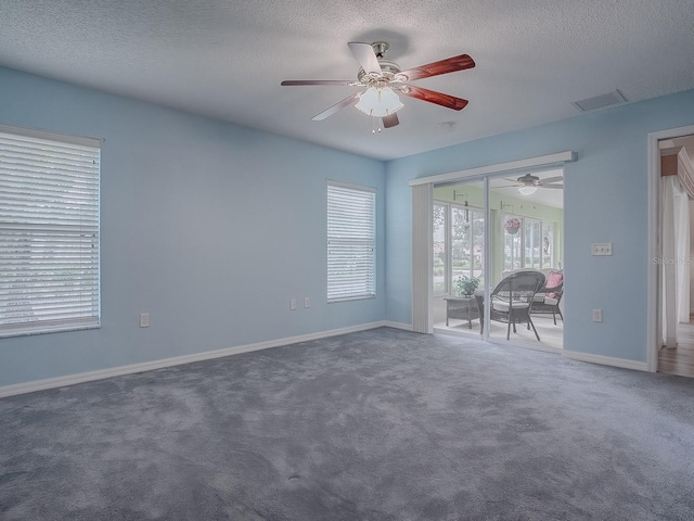 carpeted empty room featuring a textured ceiling and ceiling fan