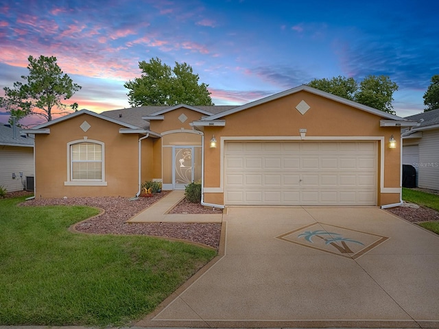 ranch-style house featuring cooling unit, a garage, and a lawn