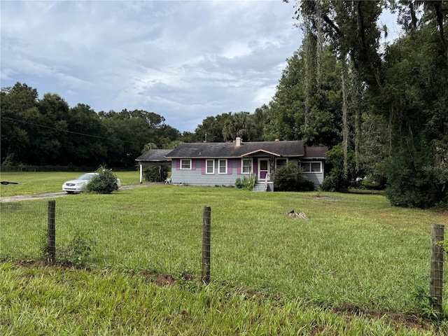 ranch-style home featuring a front yard