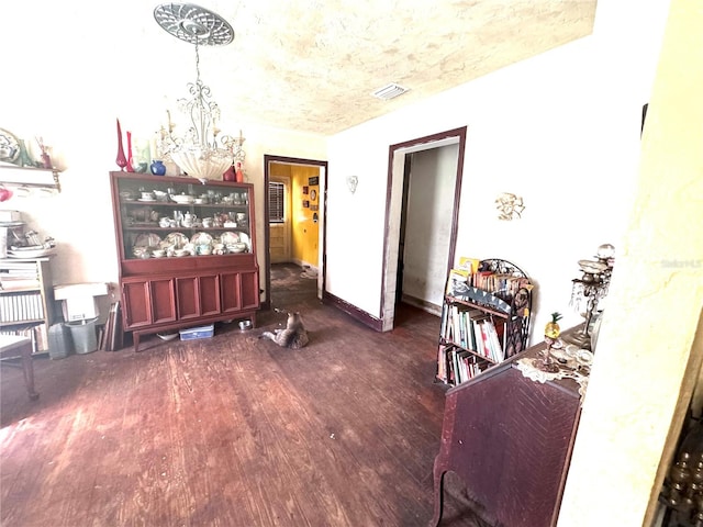 interior space featuring dark hardwood / wood-style flooring and a chandelier