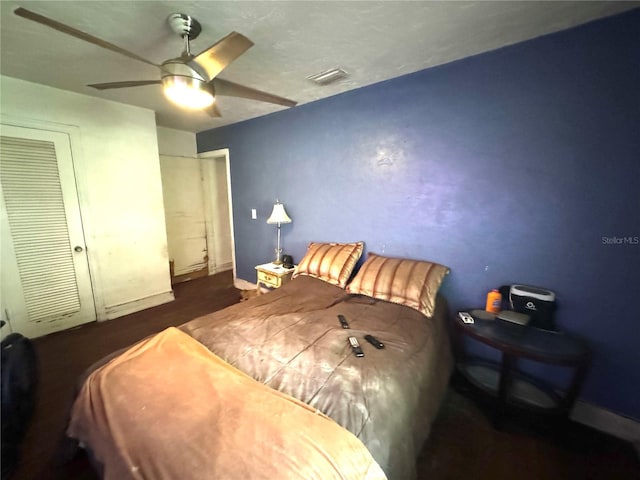 bedroom with ceiling fan and a closet