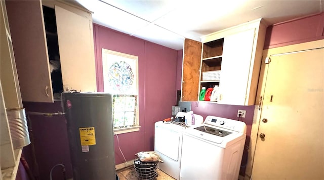 laundry area with cabinets, water heater, and washing machine and dryer