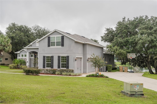 view of front property featuring a garage and a front lawn