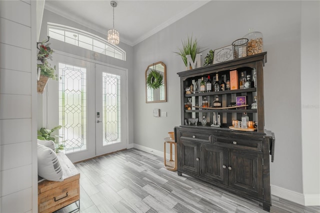 entrance foyer featuring ornamental molding and light hardwood / wood-style flooring