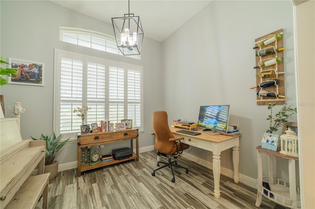 office featuring wood-type flooring and an inviting chandelier