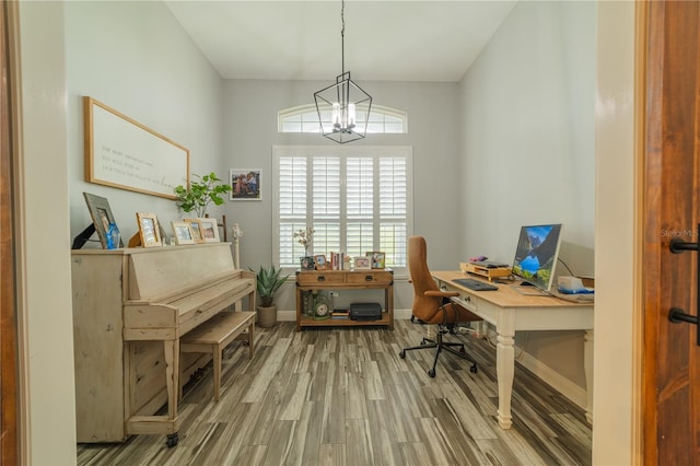 office with wood-type flooring and a chandelier