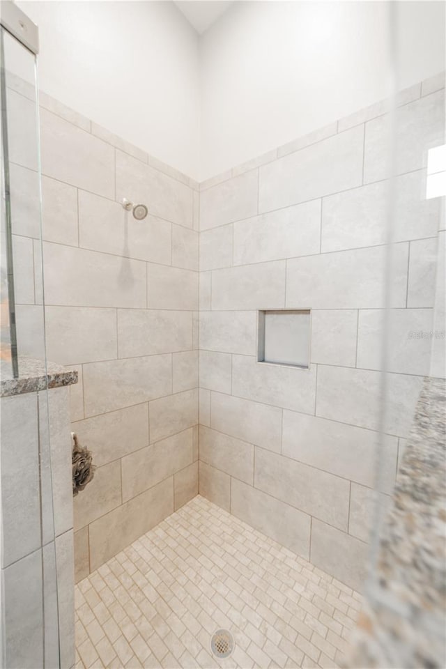 bathroom with tiled shower