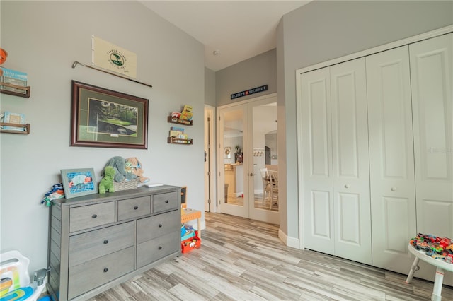 bedroom featuring light wood-type flooring, a closet, and french doors