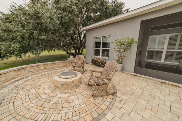 view of patio with a fire pit