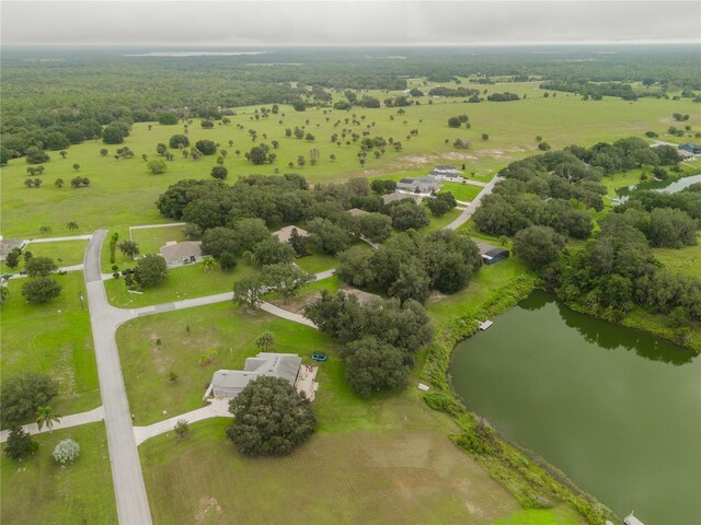 birds eye view of property featuring a water view and a rural view